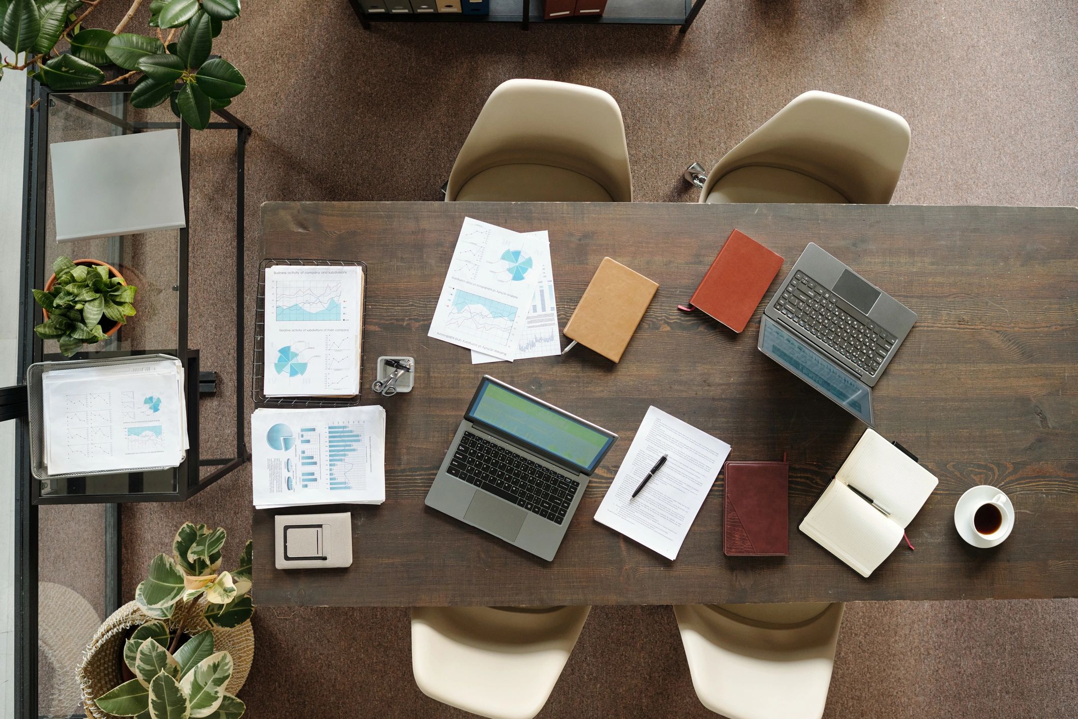 Organized marketing workspace with laptops and planning documents